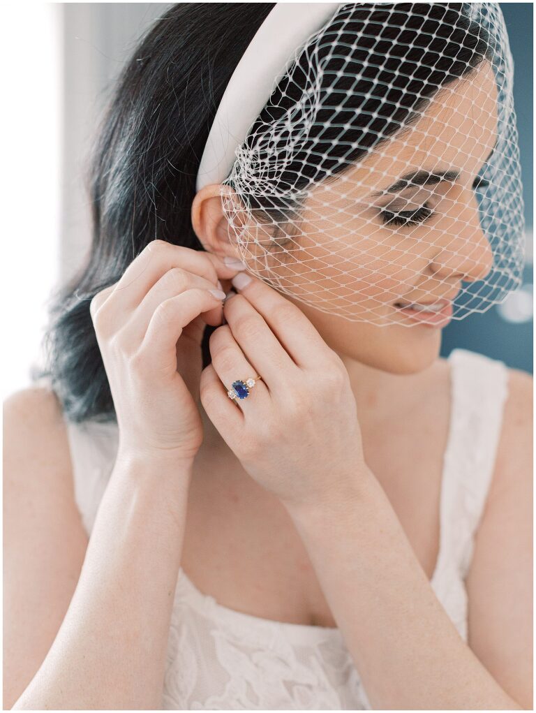 Bride putting her earrings in