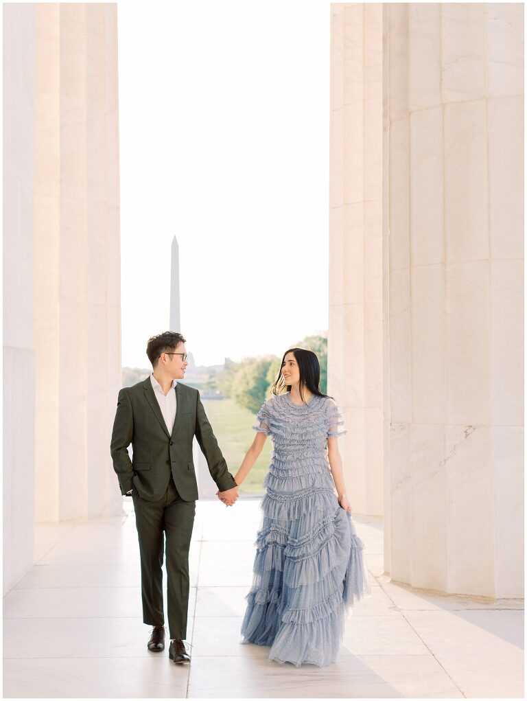 Lincoln Memorial engagement photo couple walking through columns