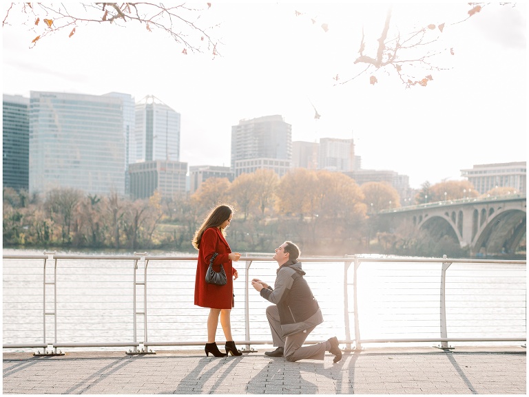 Man on knee proposing at the Georgetown Waterfront in Washington DC
